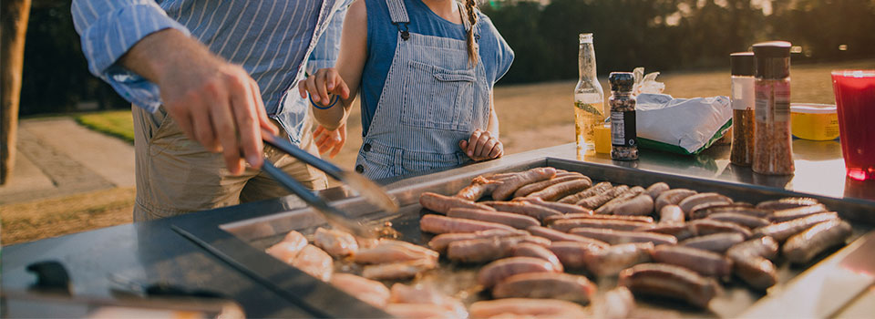 Father with daughter cooking on a griddle