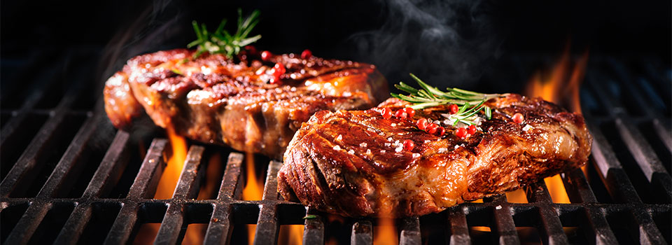 Man showing cooked steak cut