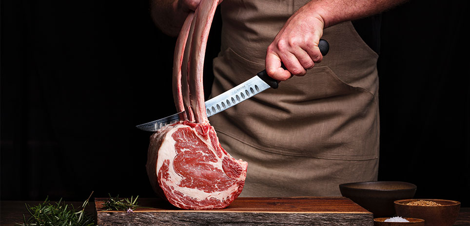 Butcher cutting steak